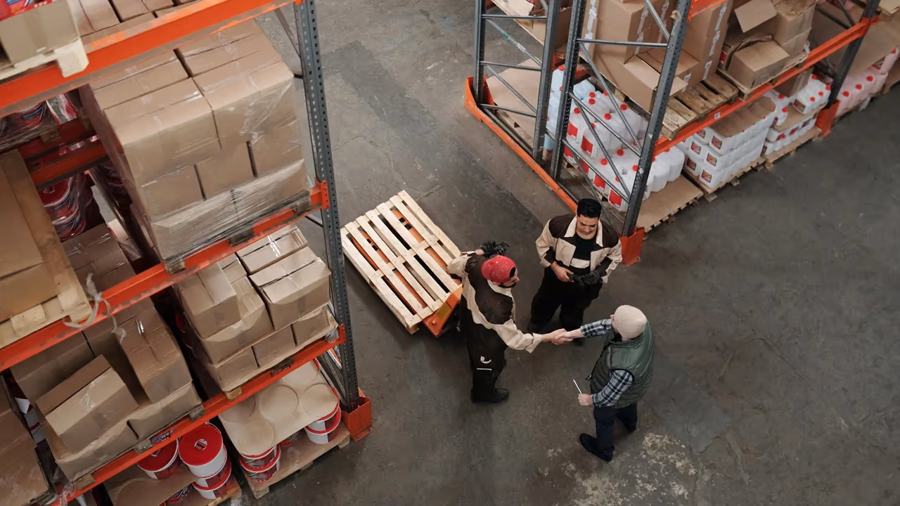 Warehouse team checking stock on pallets